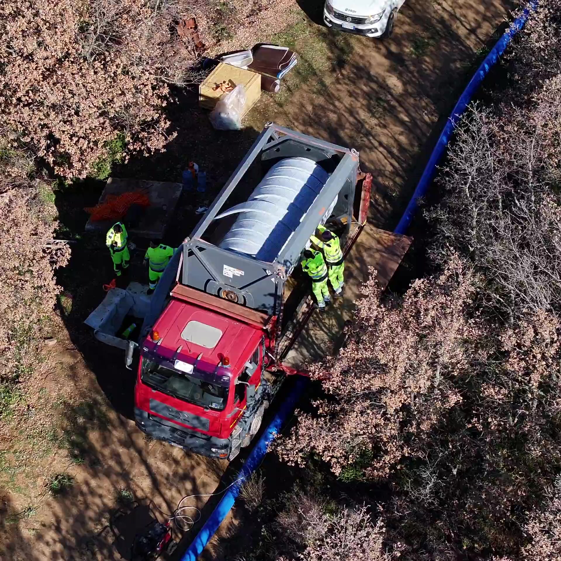 Vista aerea di un intervento SAPI con camion, operatori e condotta blu